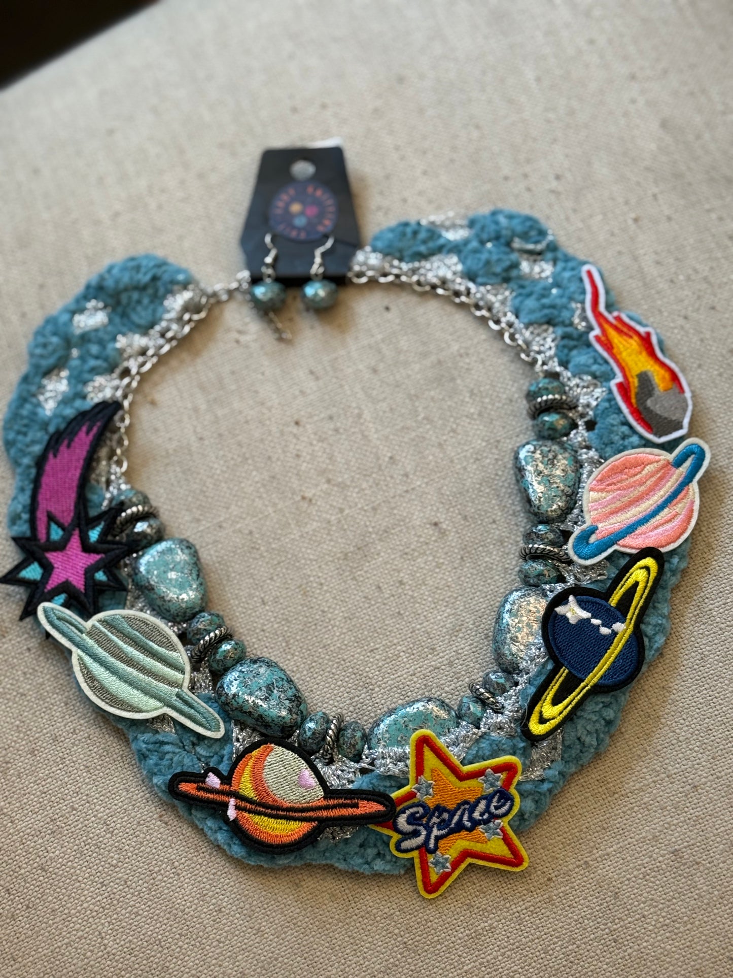 Love bomb collar and earrings: cults always promise space travel