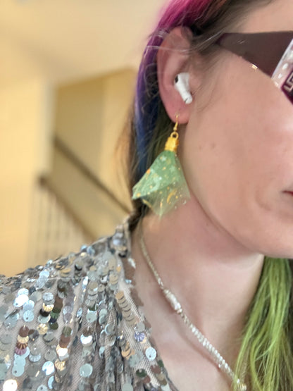 Fringe belief earrings— cults always promise space travel