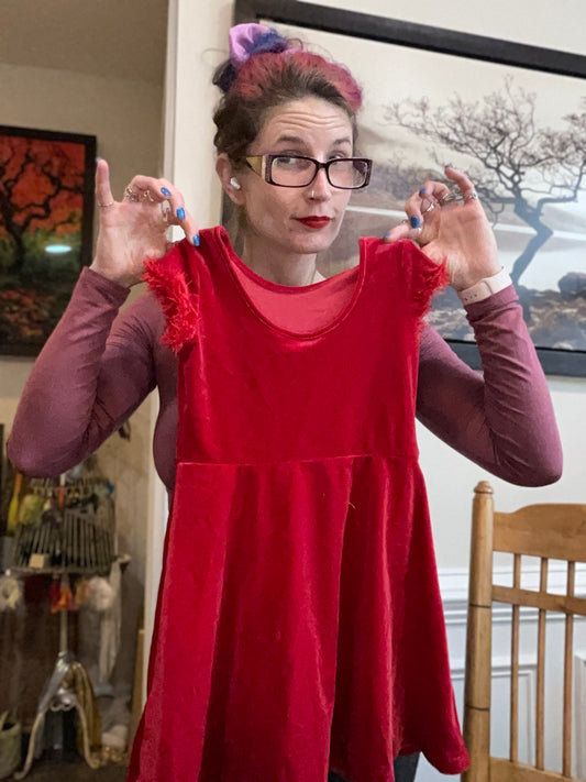 Child’s red velvet dress with fuzzy sleeve trim